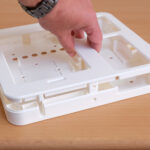 Person holding a white enclosure