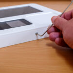 Small hex key being used on enclosure